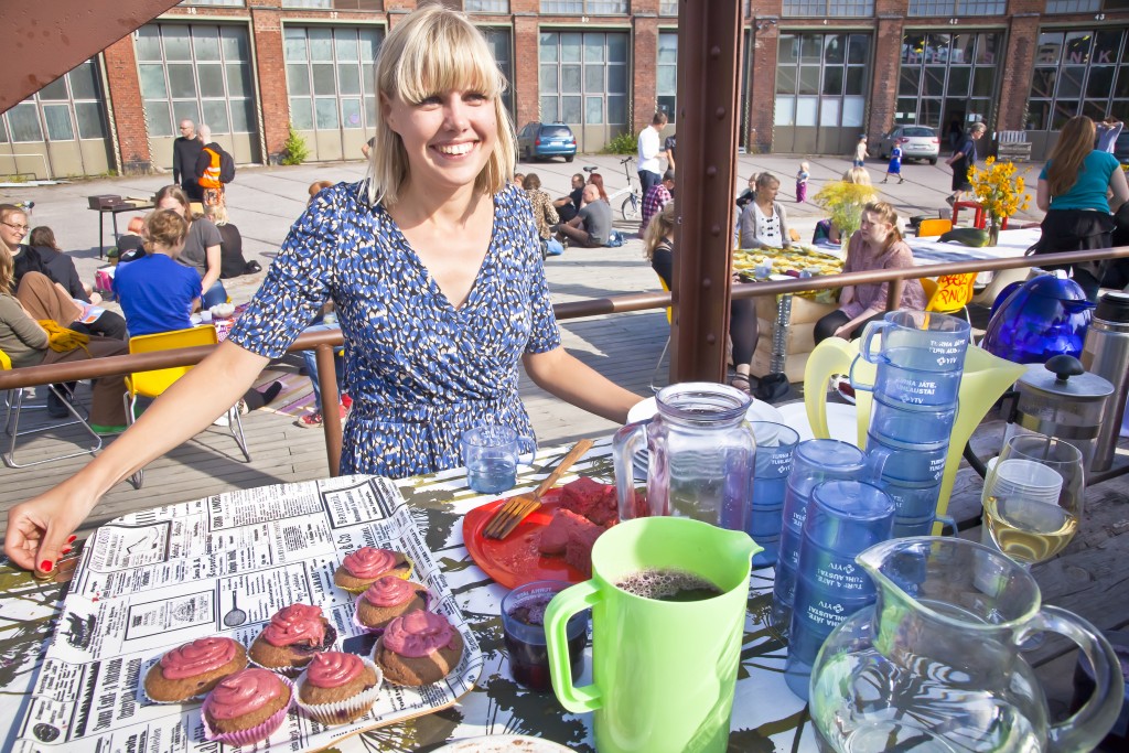 Iiris Virtasalo serves organic black currant cup cakes and blueberry juice on the international Restarant Day 21st of August 2011 at the old train depot area in Helsinki, Finland.
